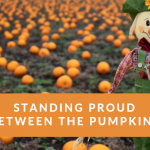 Standing proud between the pumpkins
